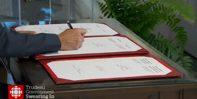 Prime Minister Justin Trudeau, signing documents