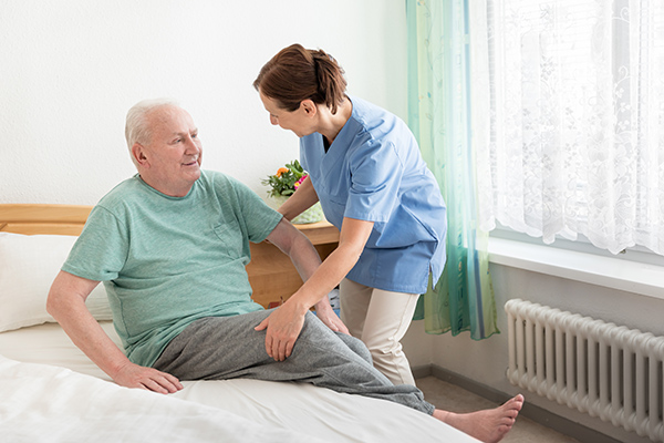 care home, lifting senior out of bed