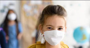 Potential COVID exposures in Island schools student, wearing face mask, COVID