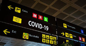 Critic roles stripped from MP who travelled internationally during COVID COVID, signage, airport, travel