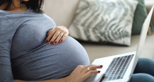 Dr Henry invites pregnant women to phone for COVID booster shots pregnant, woman, computer