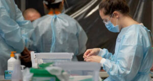 COVID immunization still required for health-care workers nurse, mask